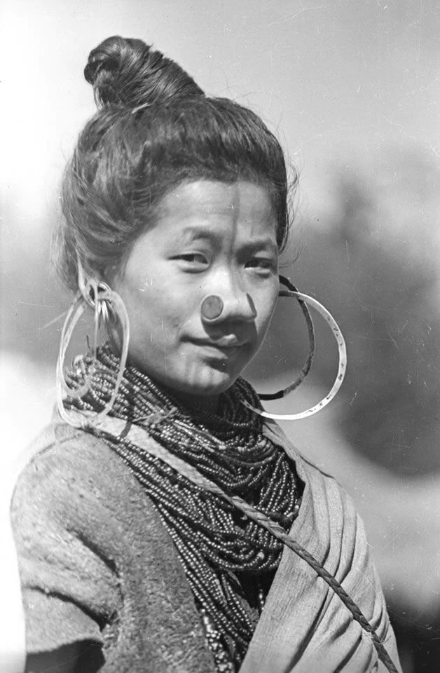 This Apatani woman is Tage Yaring, the fourth wife of Ponyo Tamar, an influential man in Hong Village, Apatani valley, Lower Subansiri District. ca. 1944 | © Nicholas Fürer-Haimendorf